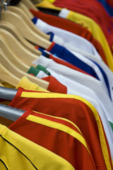 sport shirts hanging on a rack at a sporting goods store